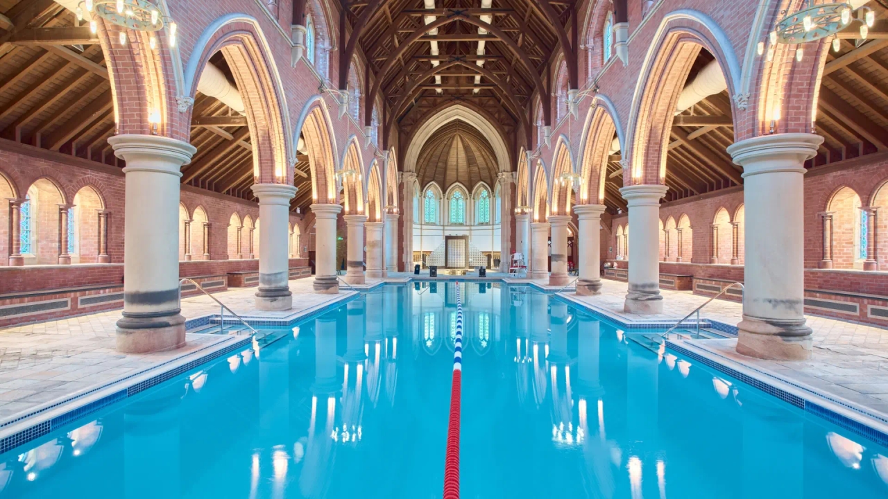 The Gothic church converted into a gym with a huge swimming pool and a sauna in the confessional